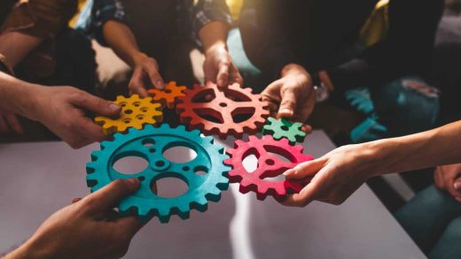 shutterstock 2270669753 teamwork concept team putting colored gears together