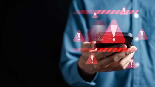 System warning caution sign on smartphone, scam virus attack on firewall for notification error and maintenance. Network security vulnerability, data breach, illegal connection and information danger.