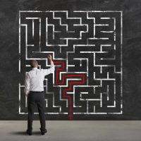 Complexity, problem solving. Man solves a maze.