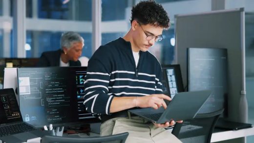 Man, programmer and office with laptop for coding, software development or app design. Male person, coder or developer with computer or technology for cybersecurity, web or IT services at workplace