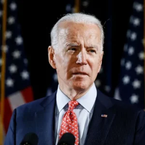 Joe biden speaking podium american flags