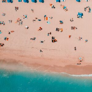 Aerial beach view umbrellas people