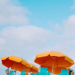 Beach chairs under orange umbrellas