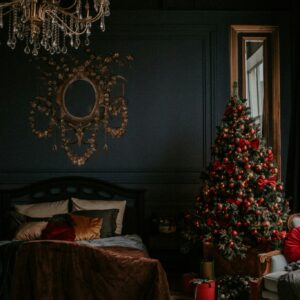 Cat napping by decorated christmas tree