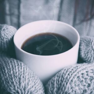 Cozy sweater steaming coffee cup