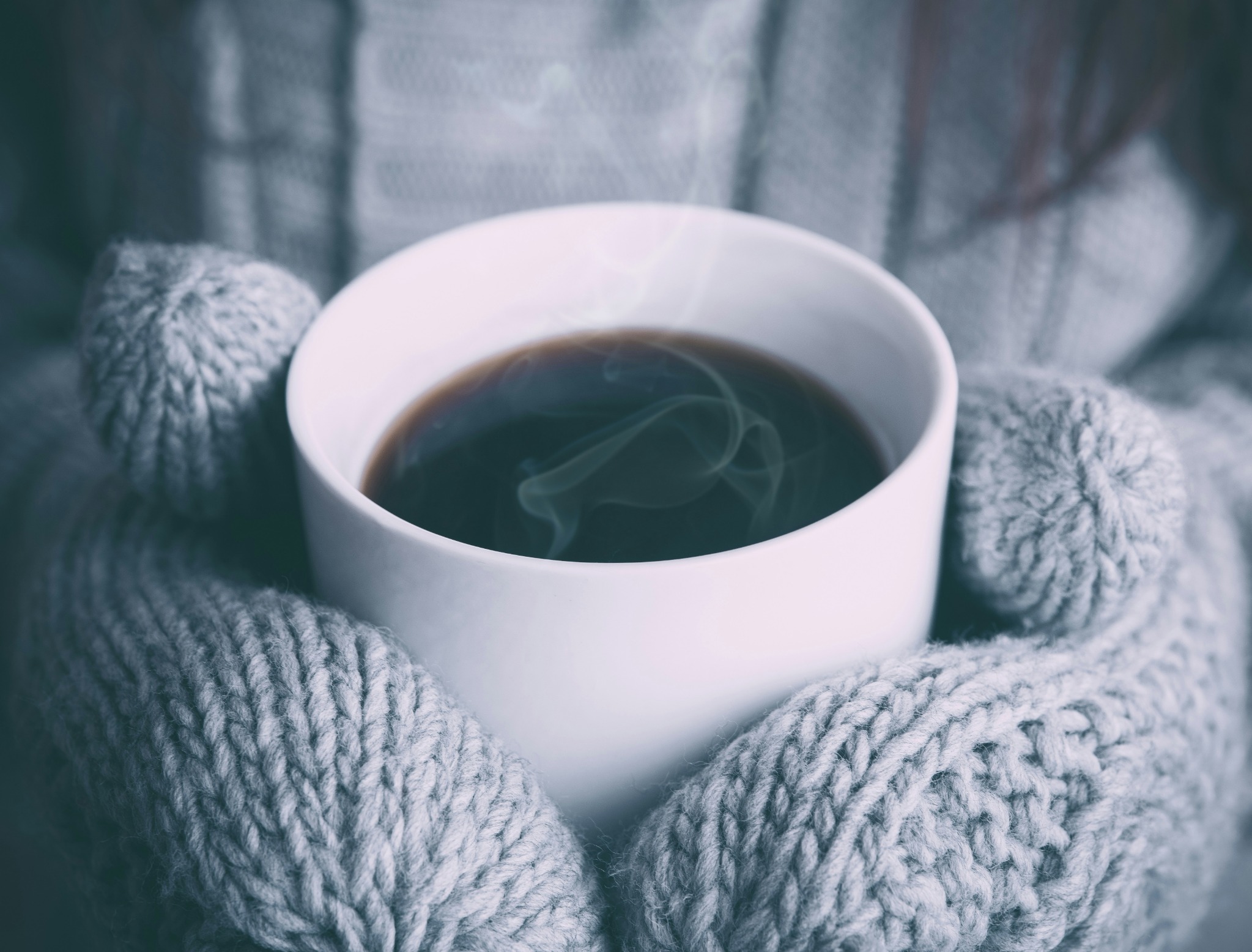 Cozy sweater steaming coffee cup