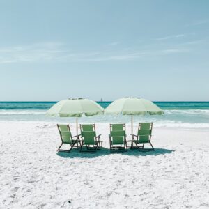 Green beach umbrellas chairs