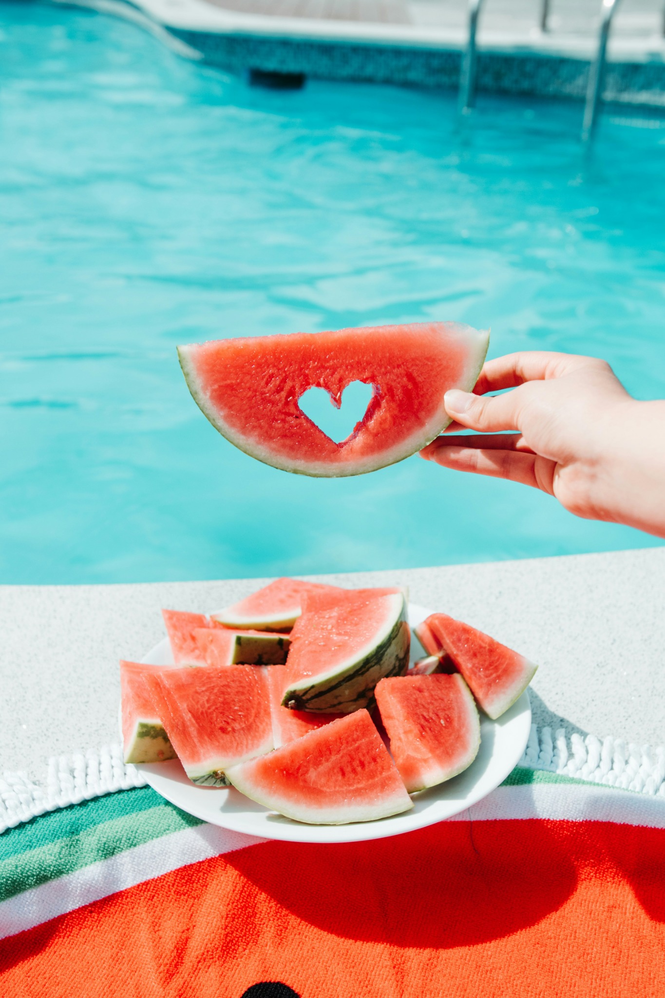Heart shaped watermelon slice poolside