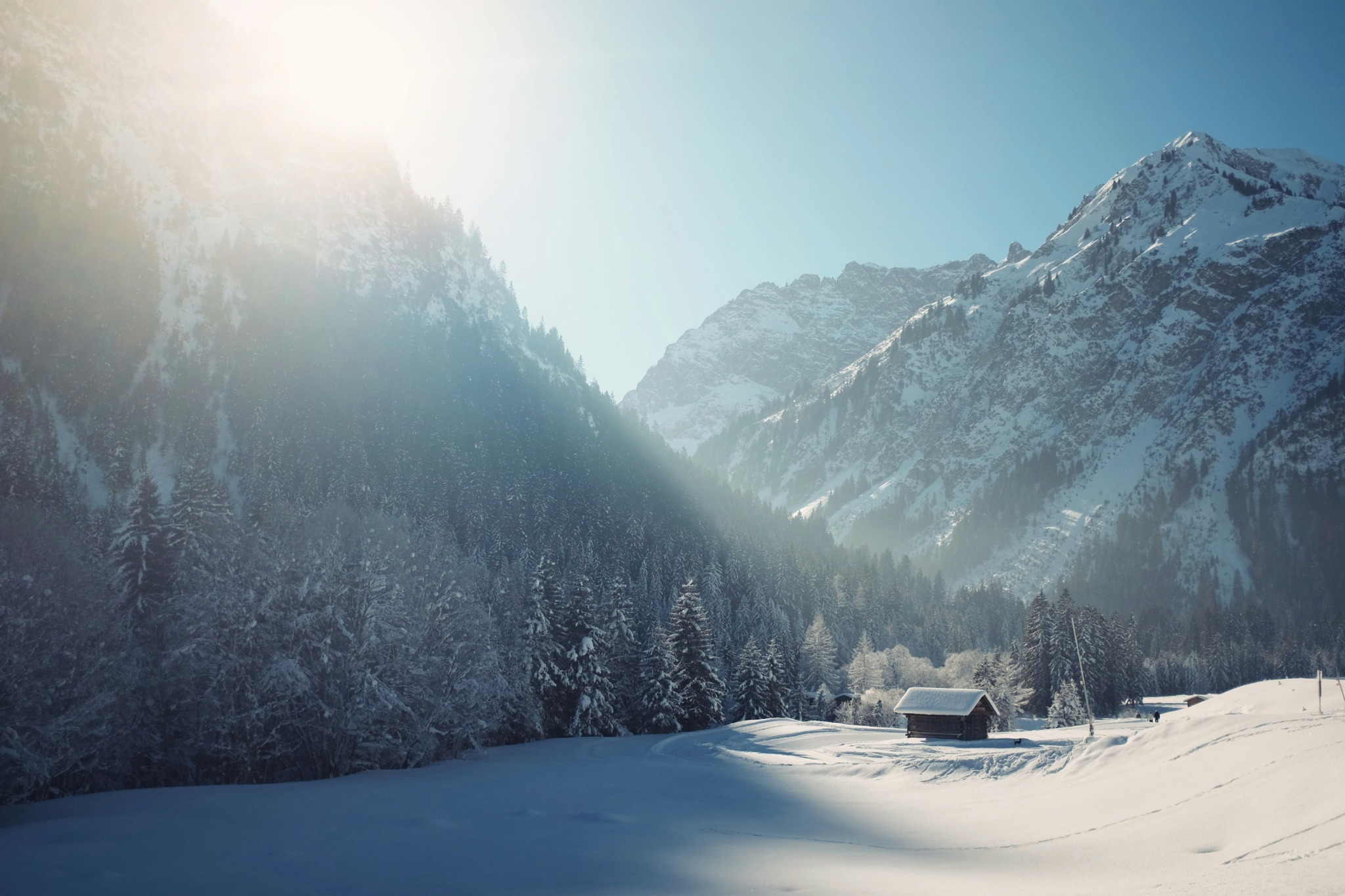 Snow covered chalet sunlight