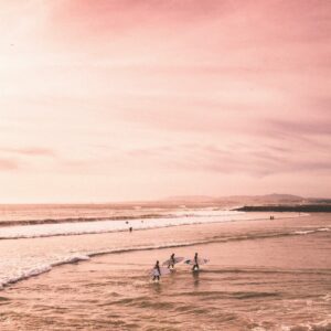 Surfers beach sunset pink sky