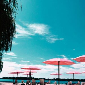 White beach umbrella blue chairs