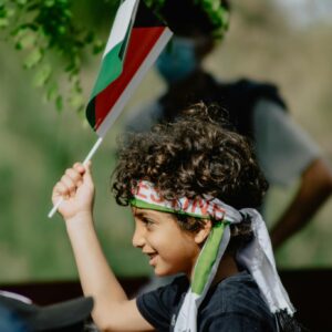 Young boy holding palestinian flag wallpaper