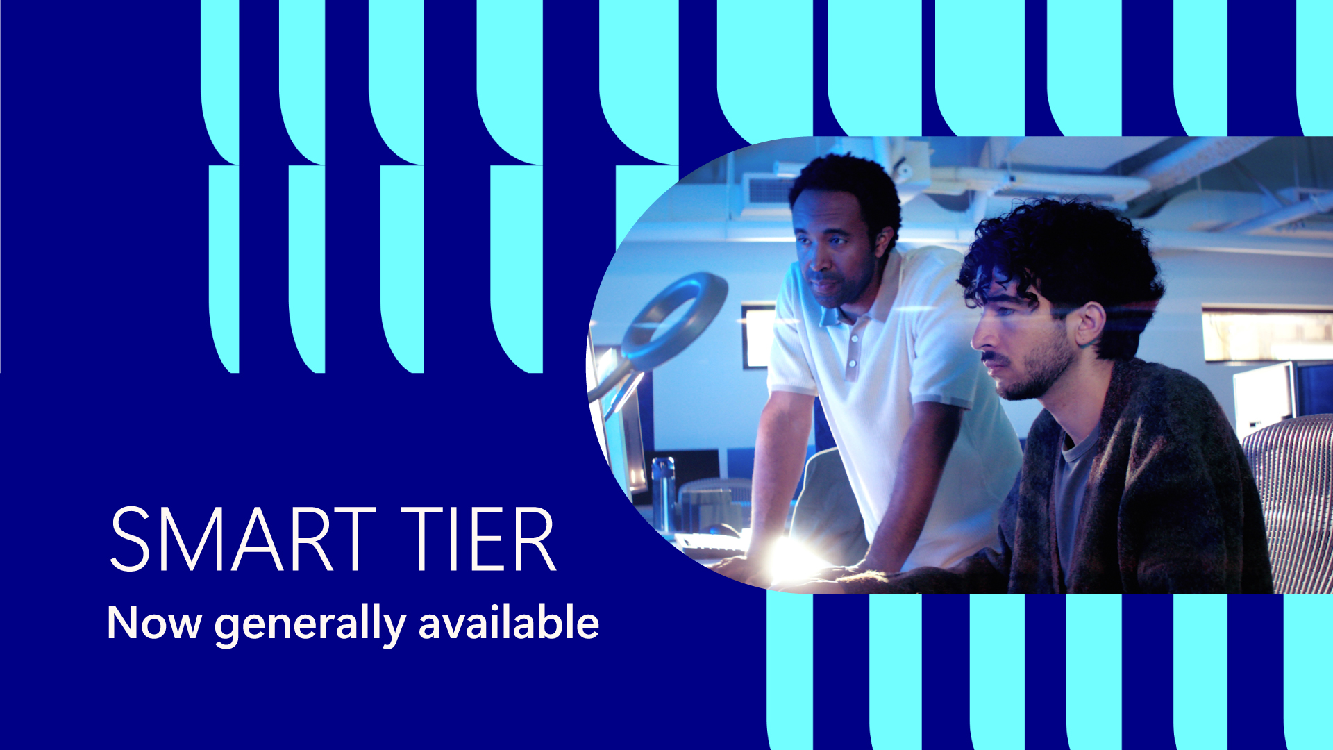 Two people working at desk. Text reads "Smart tier. Now generally available."