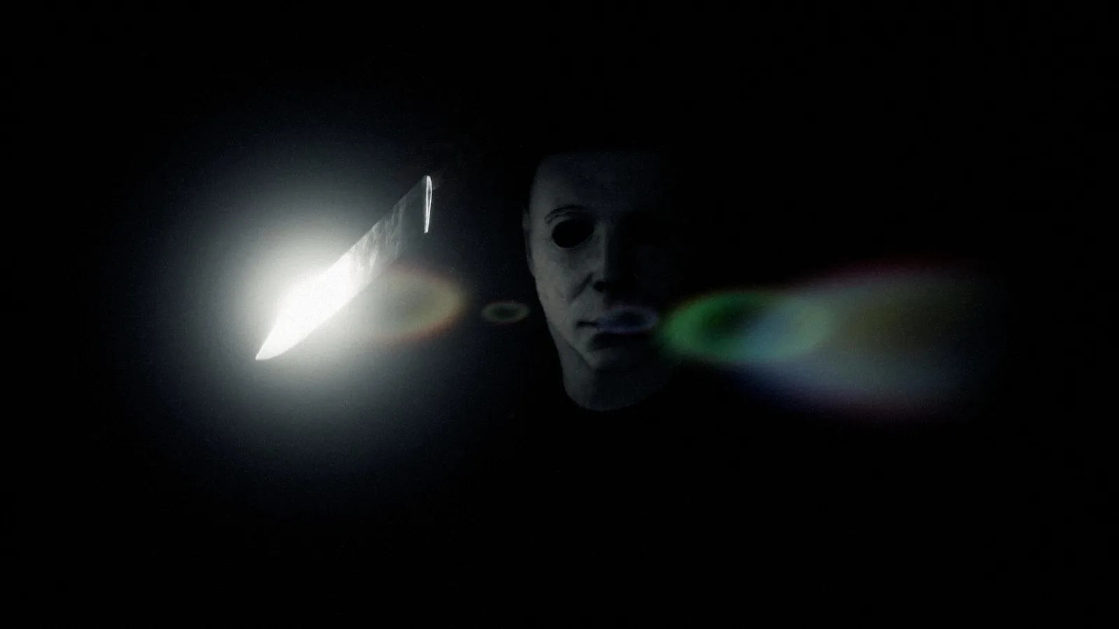 Michael Myers barely visible in near total darkness with a knife blade catching a point of light