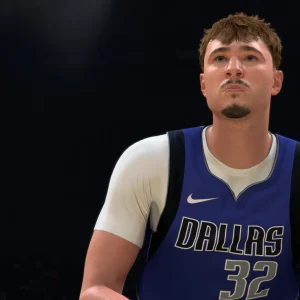 Close up of a Dallas Mavericks player in a blue number 32 jersey on a darkened court in NBA 2K27