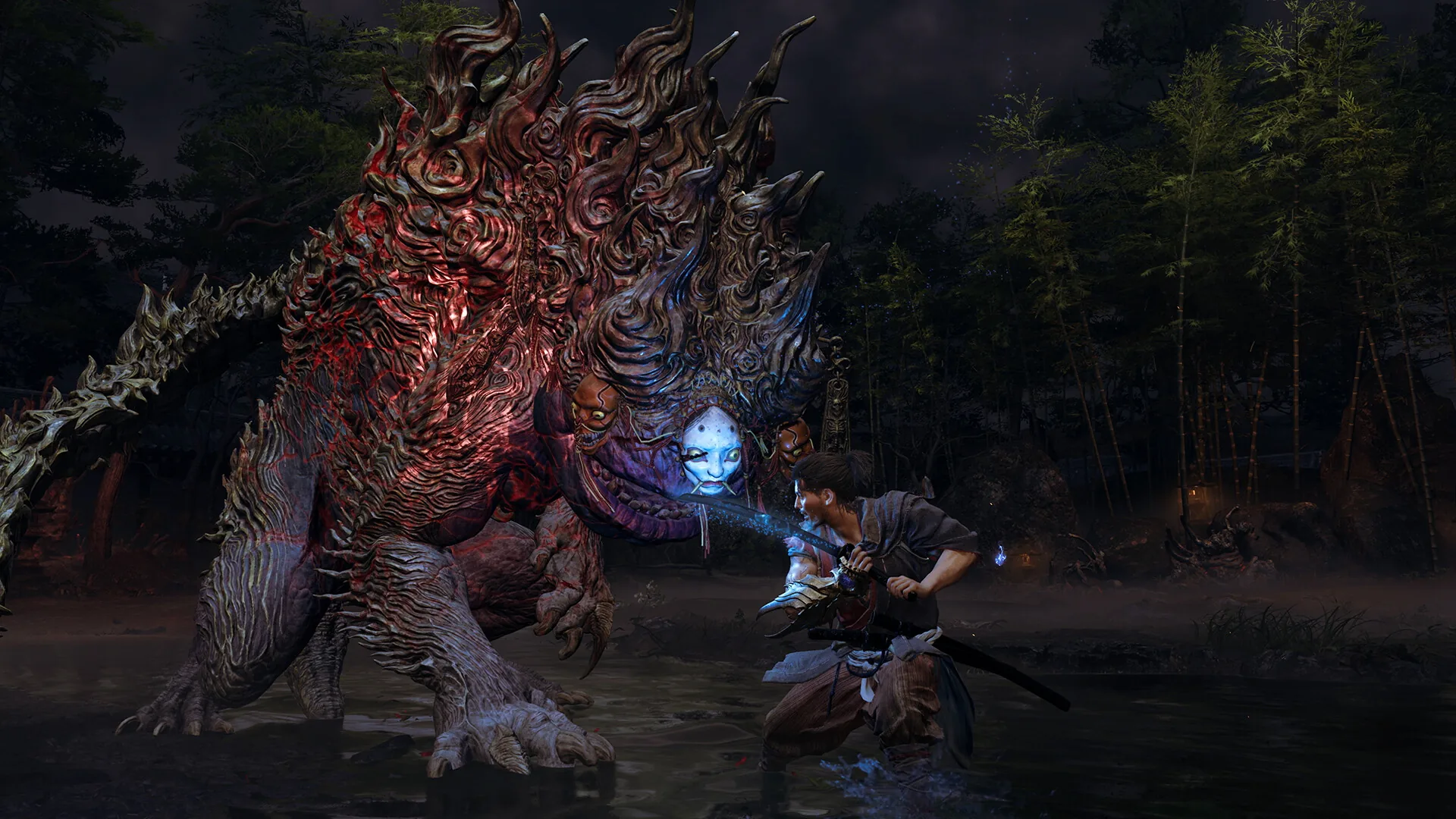 Musashi stands knee deep in a river at night facing a huge four-legged Genma covered in faces
