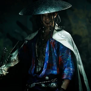 A smiling swordsman in a wide metal hat and a blue and red patterned robe stands in shadow