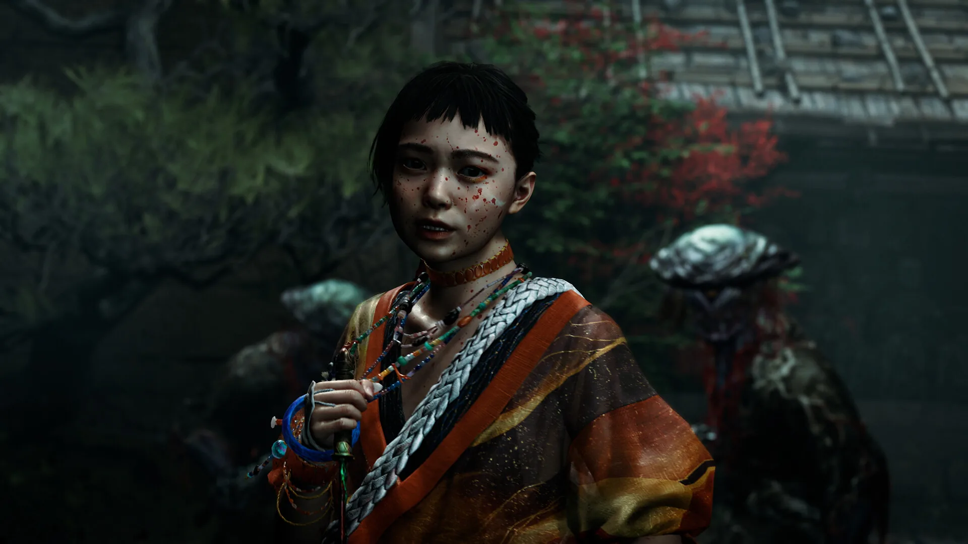 Close up of a young character in a striped orange kimono holding a small blue trinket, with a Genma behind her