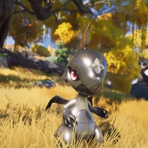 A small silver Aniimo with red eyes standing in tall golden grass under autumn trees