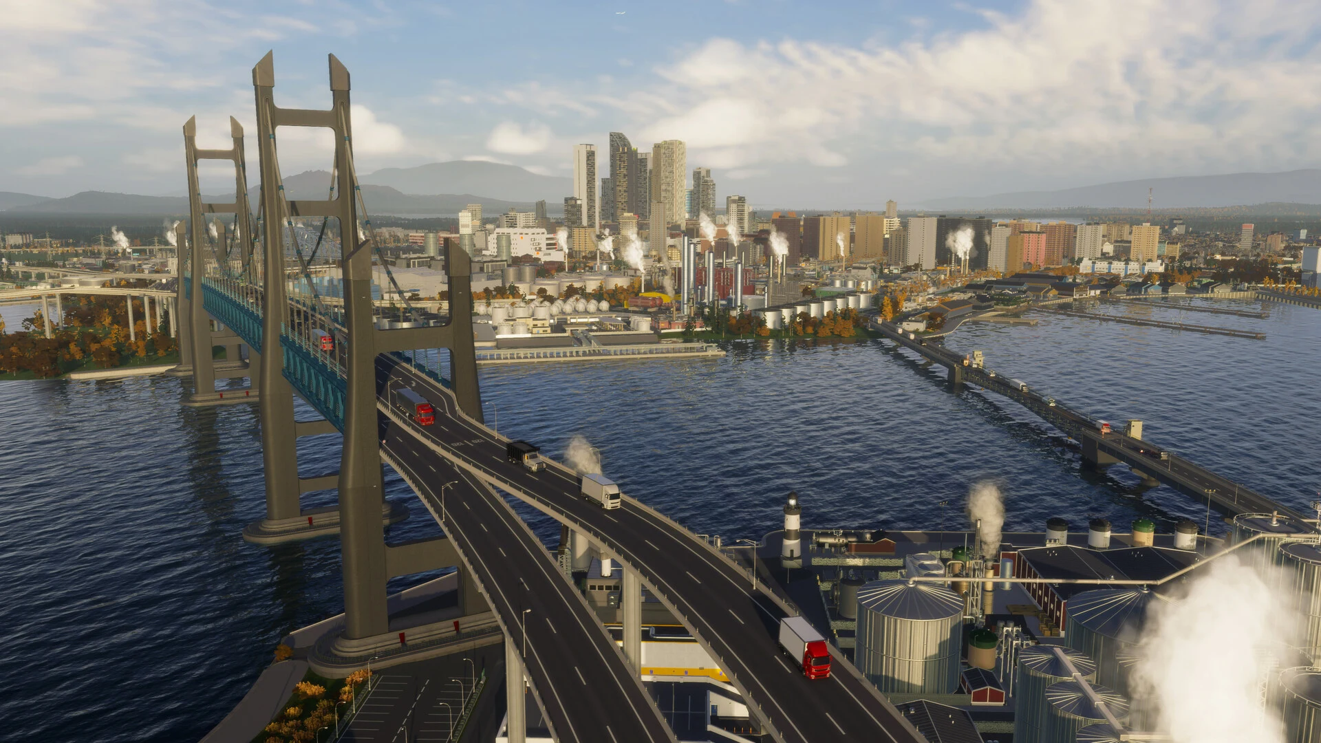 A double suspension bridge carries traffic across a bay toward a downtown skyline