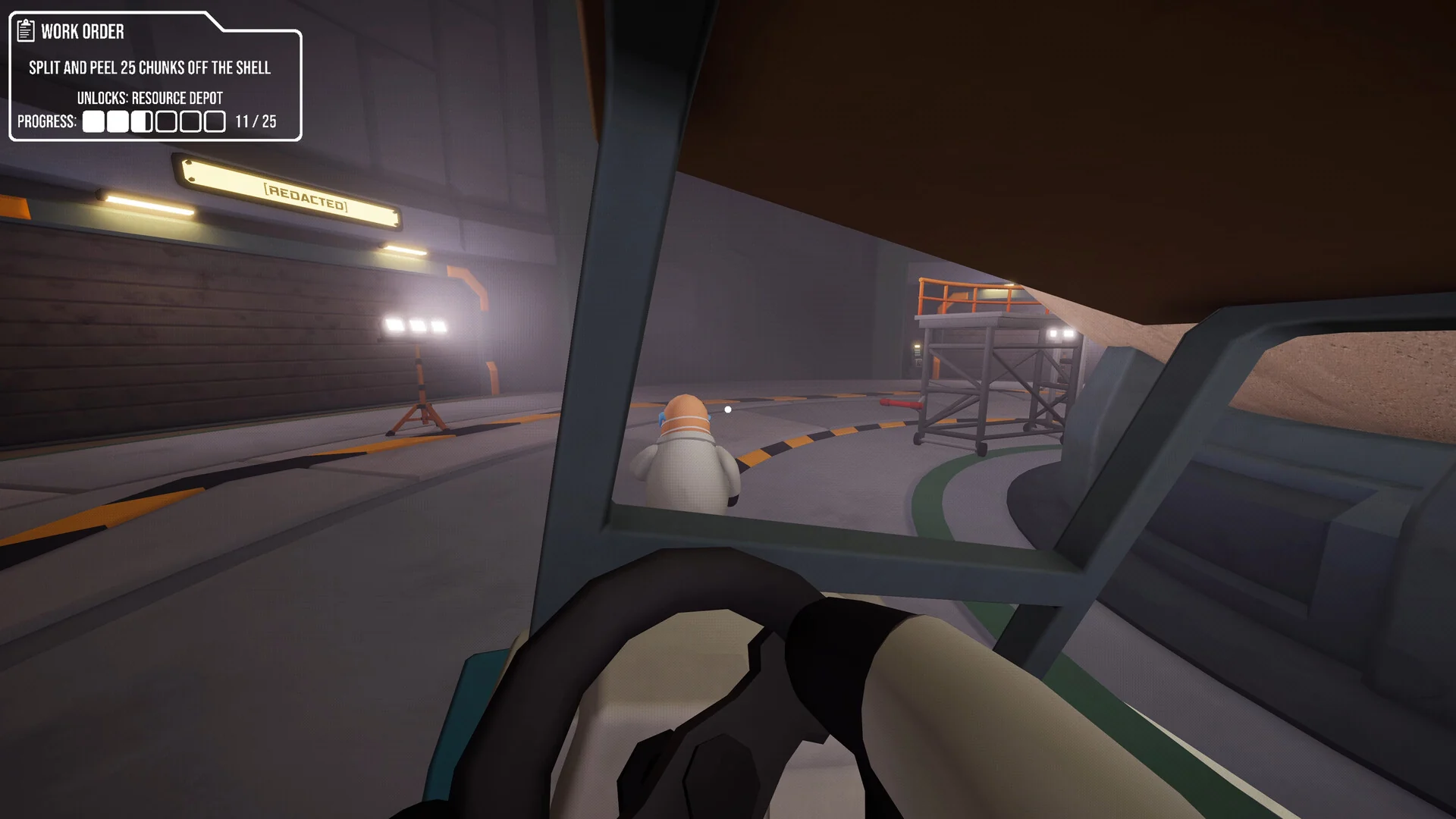 First-person view from the driver's seat of a golf cart rolling across the dim lab floor toward another worker