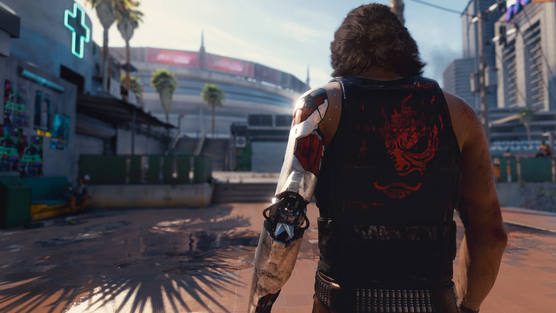 Johnny Silverhand, with a silver cyber arm and a sleeveless shirt, seen from behind on a sunny plaza