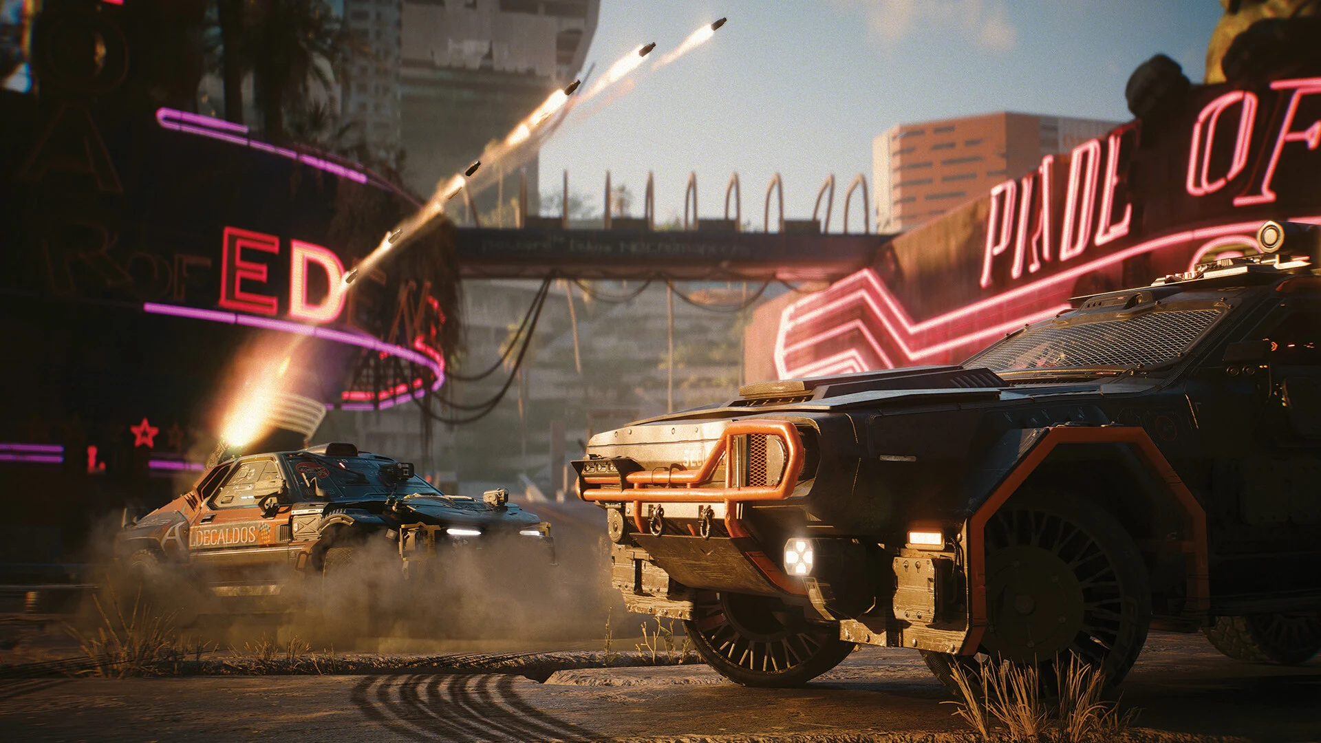 Two armored cars trade rocket fire under a neon Pixel Orbit sign