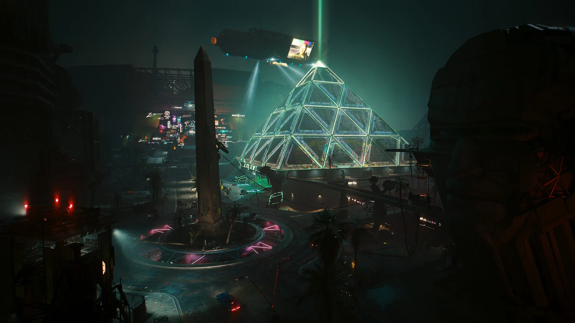 The Dogtown district at night, with a glowing glass pyramid, an obelisk and a crowd of market stalls below