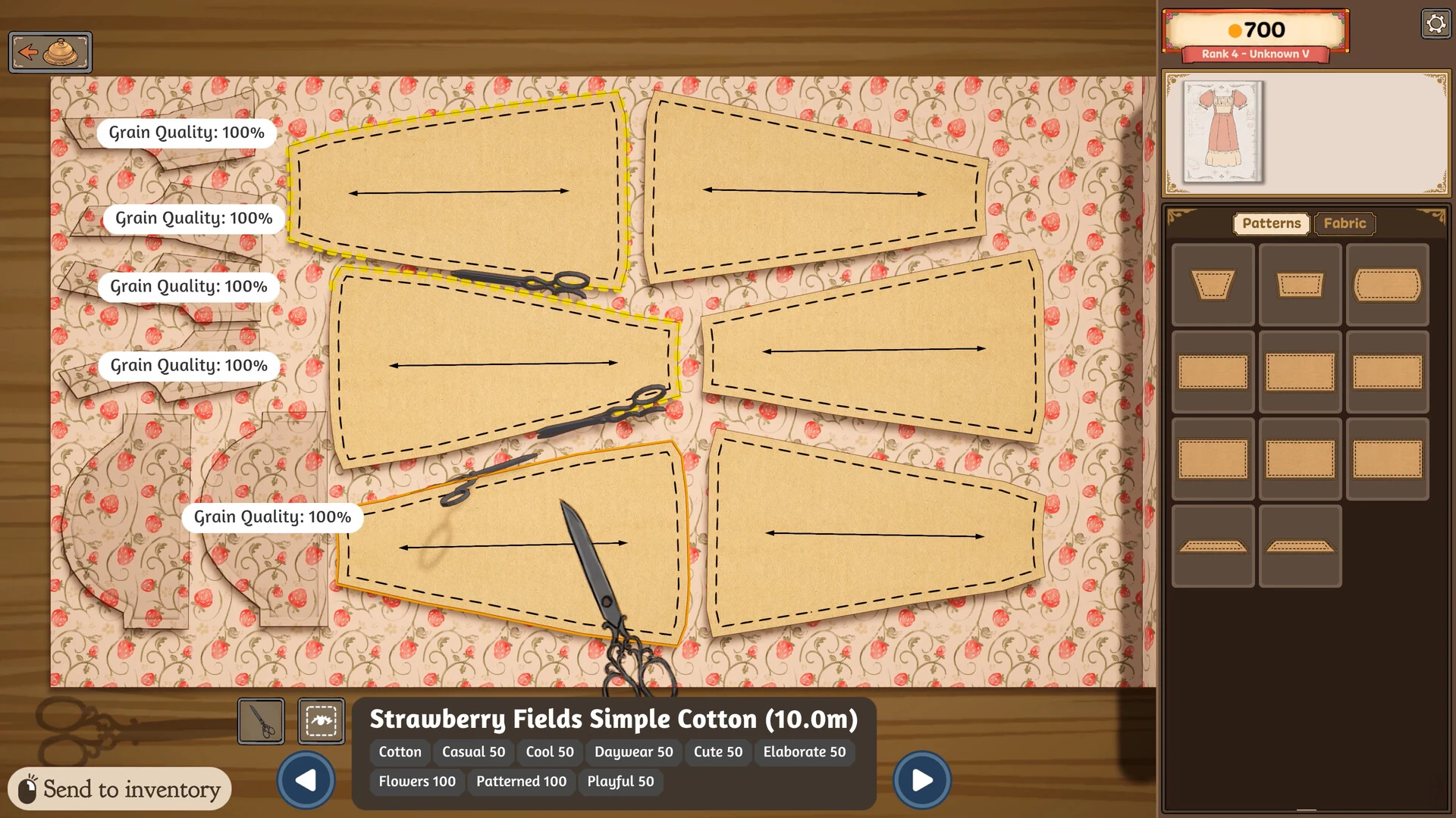 Pattern pieces laid on strawberry print cotton in the Dressmaker cutting room, each with a grain arrow and a grain quality score, while scissors cut one out
