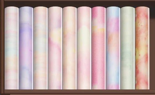 Rolls of pale watercolor-textured cotton fabric in pink, lilac, peach and mint on the Dressmaker fabric shop shelf