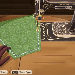 Green patterned fabric being fed through a vintage sewing machine in Dressmaker, with on-screen keys for sew, rotate and change speed