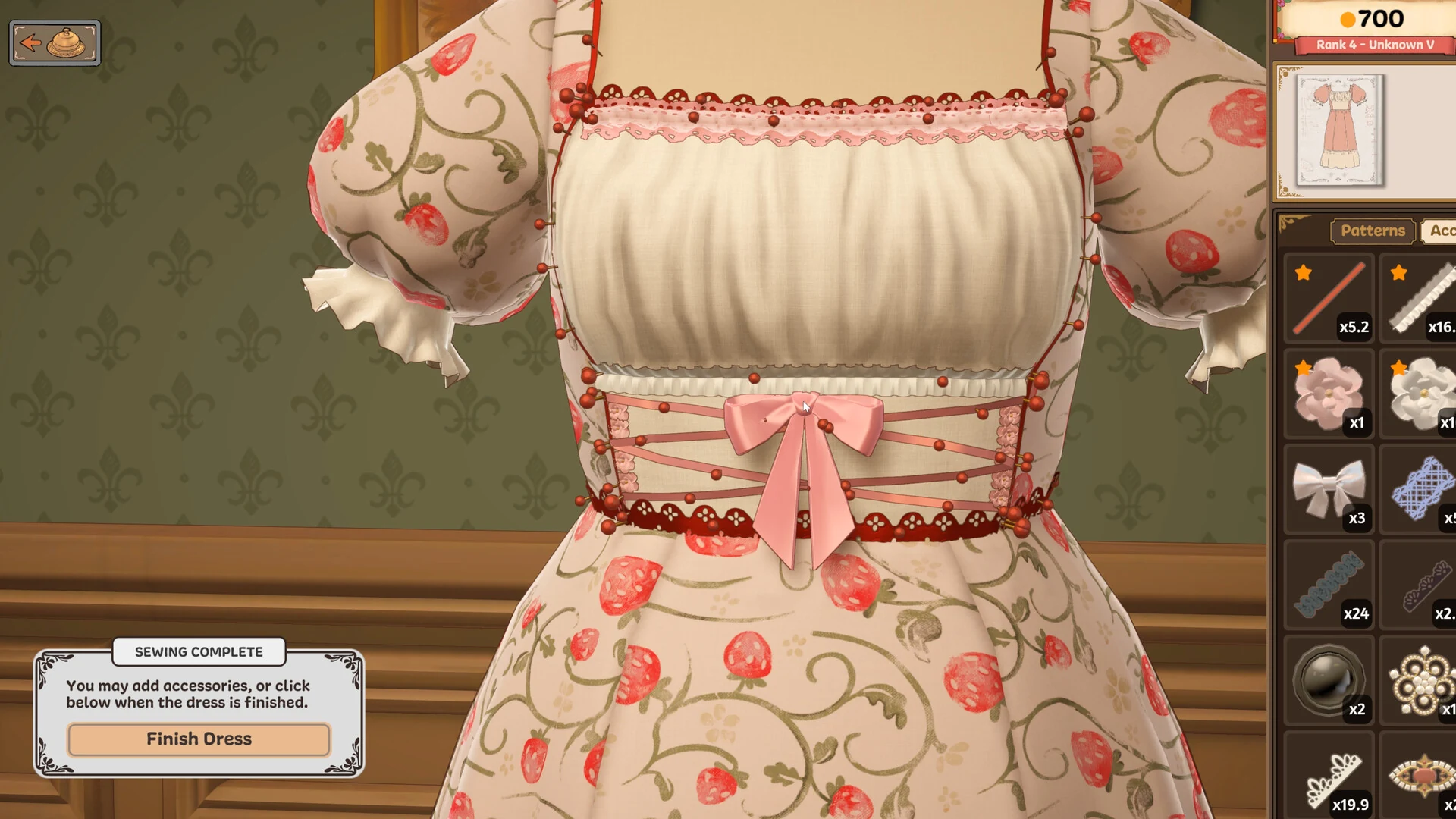 A close view of a strawberry print cotton dress with puff sleeves, lace trim and a pink laced bow at the waist in Dressmaker, with an accessories panel on the right