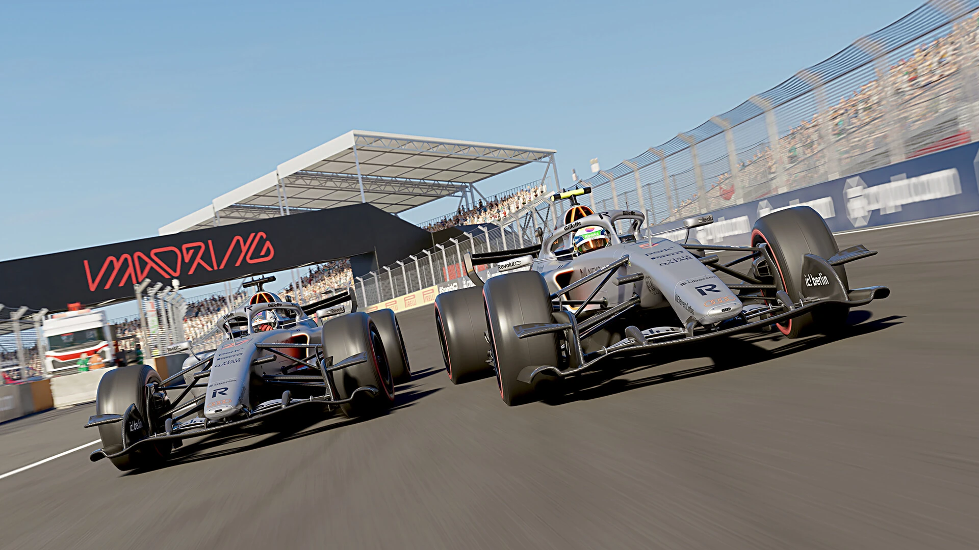 Two 2026 cars race down the main straight at Madring in Madrid, under the Madring gantry and grandstand in F1 25