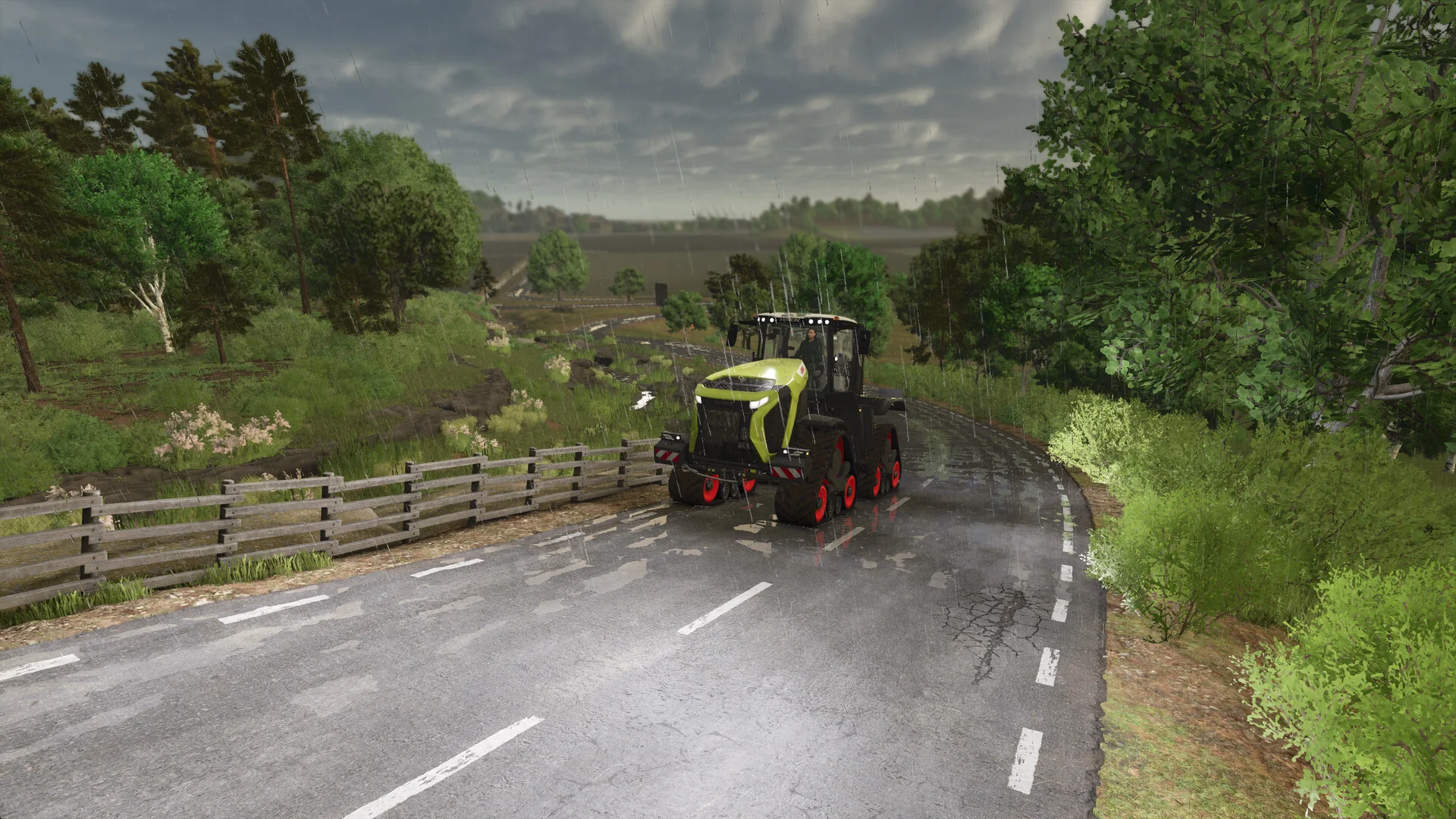 A green CLAAS tracked tractor drives along a winding country road lined with trees and a wooden fence in Farming Simulator 25
