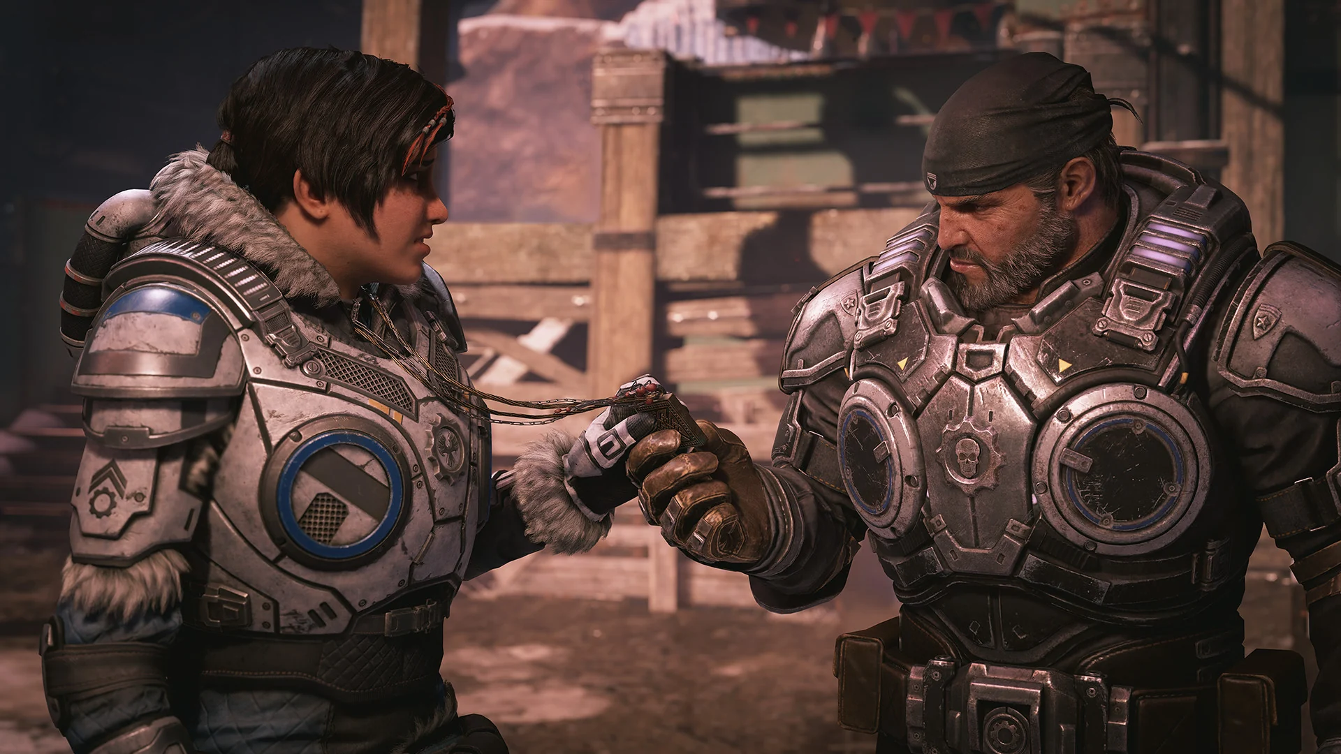 Kait Diaz hands a small locket on a chain to Marcus Fenix
