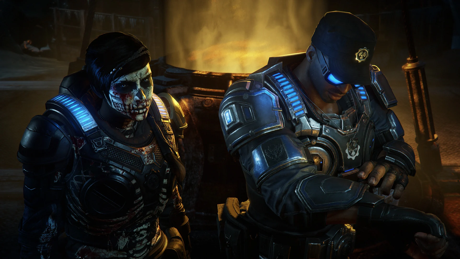 Kait Diaz with skull face paint sits next to a soldier with glowing blue armor lights