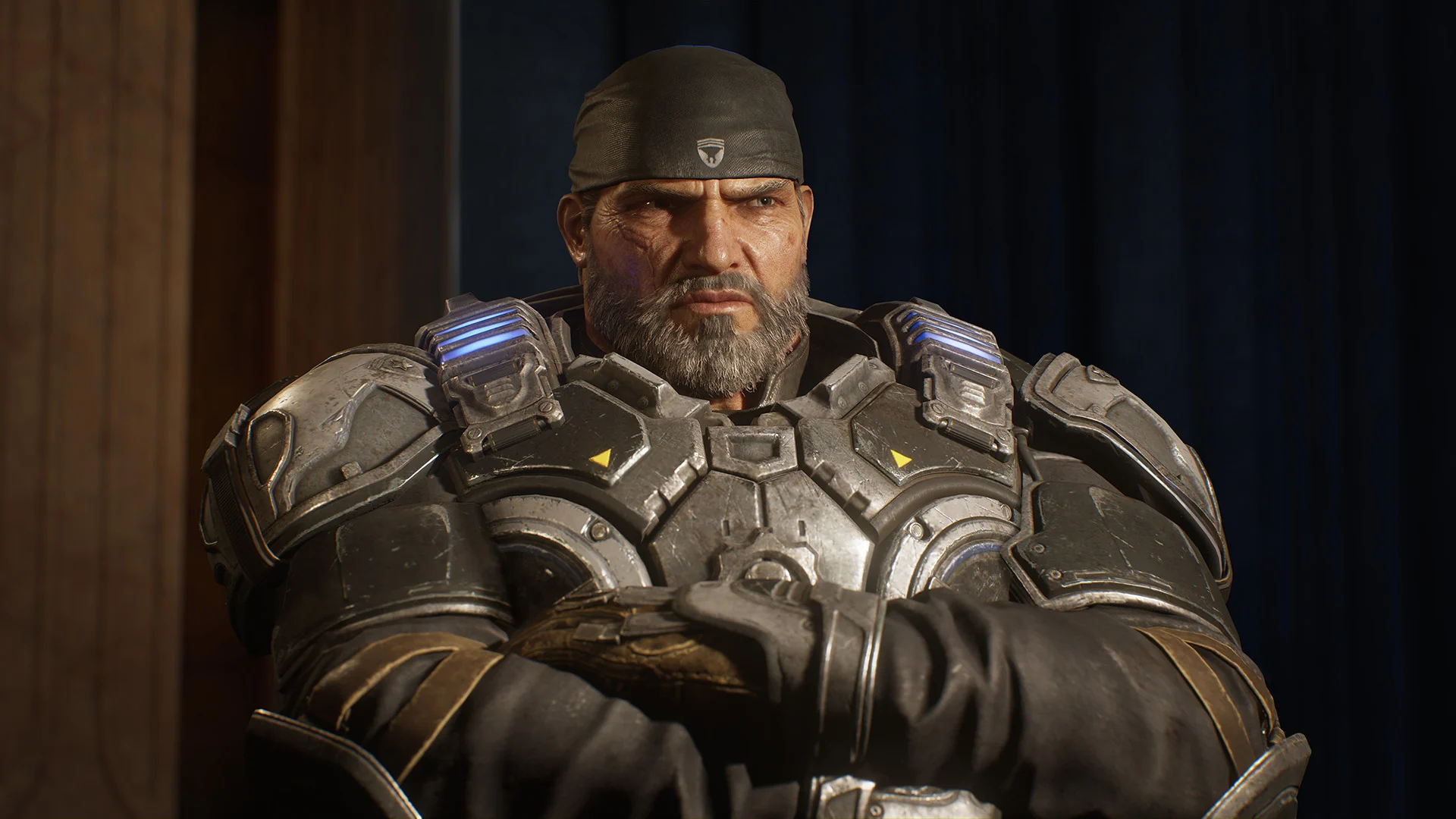 An older, bearded Marcus Fenix in a bandana sits with his arms crossed