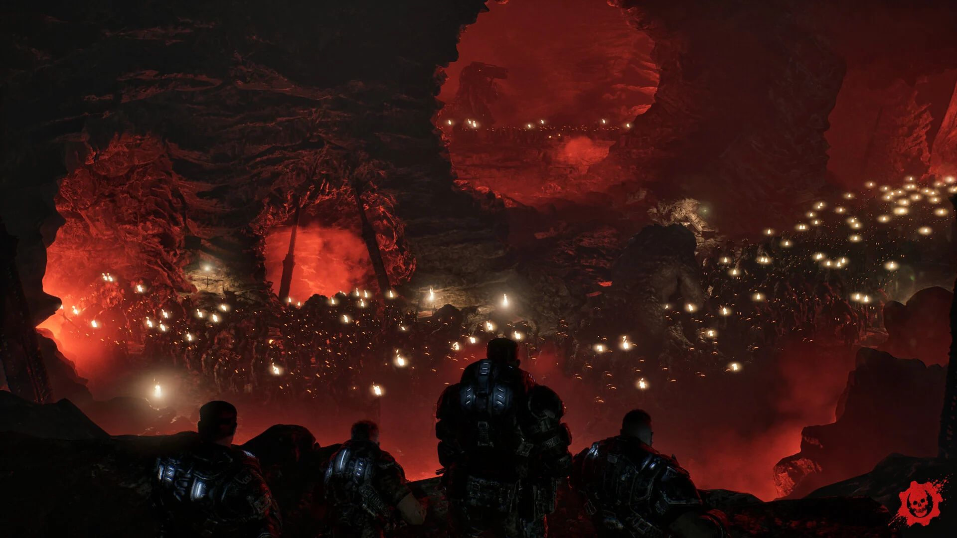 A squad of soldiers looks out over a huge underground cavern lit red, filled with thousands of glowing Locust eyes