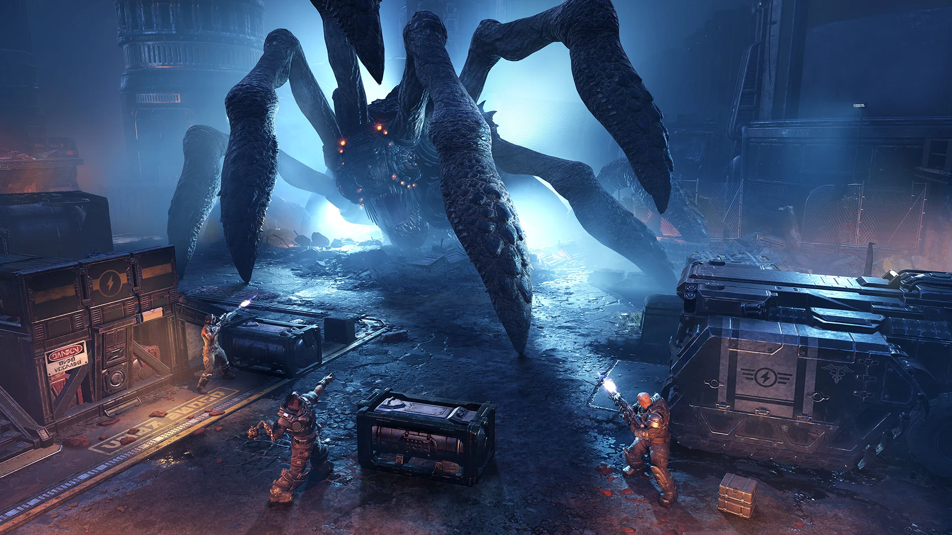 A giant many-legged boss towers over a squad of soldiers in a dark blue-lit area