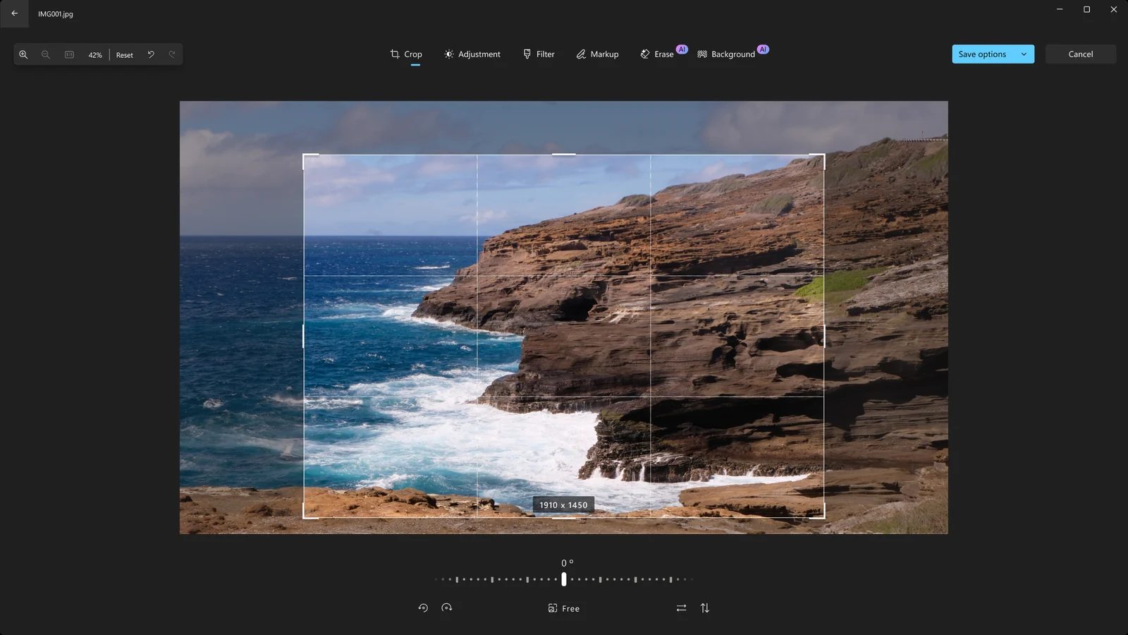 Microsoft Photos edit mode cropping a coastal cliff photo, with Crop, Adjustment, Filter, Markup, Erase and Background tools along the top