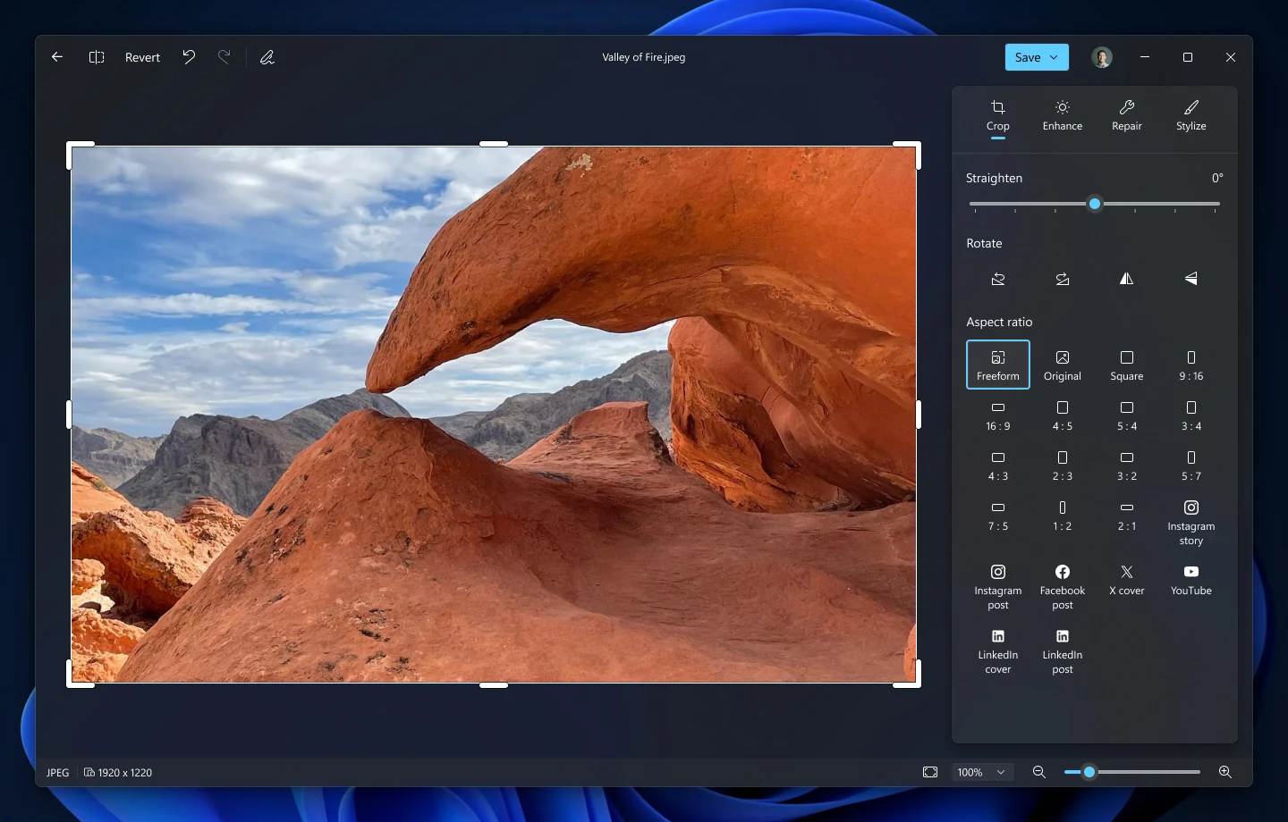 New Microsoft Photos editor with Crop, Enhance, Repair and Stylize tabs, showing aspect ratio and social media crop presets beside a desert rock arch photo