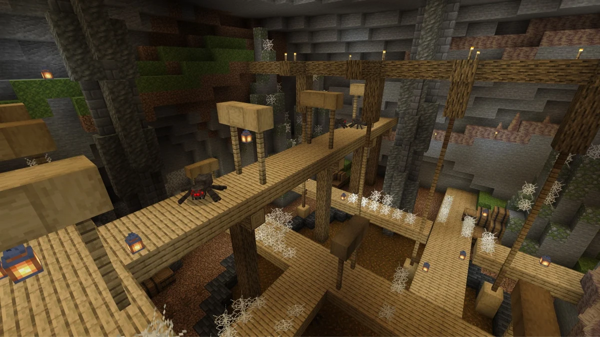 Wooden walkways, cobwebs and a cave spider inside an abandoned Minecraft mineshaft lit by lanterns