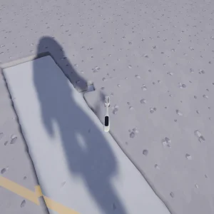 The astronaut's shadow falls across a clean path brushed through the cratered lunar dust