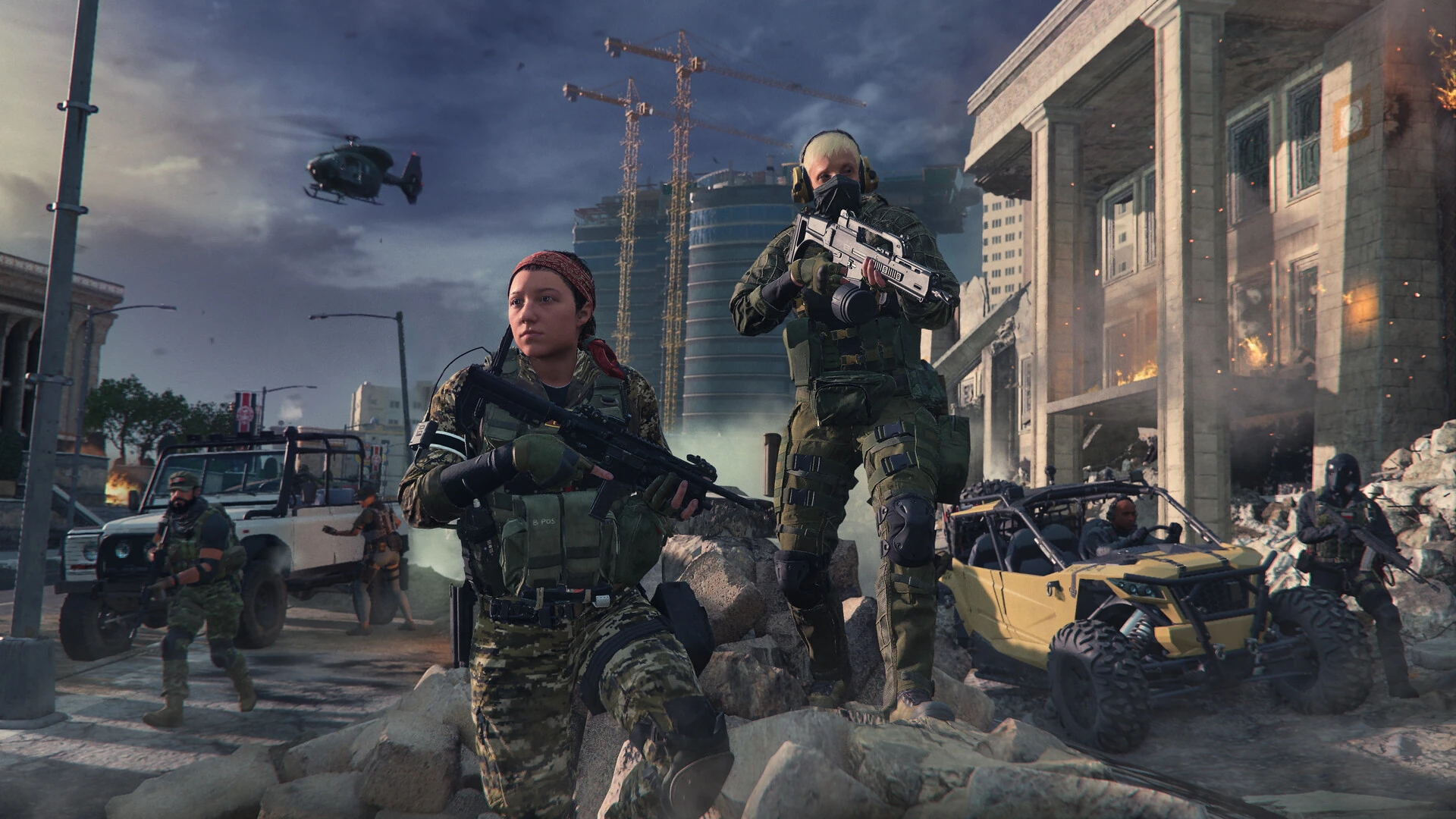 A squad of armed operators walks down a damaged city street with an off-road buggy and a helicopter overhead