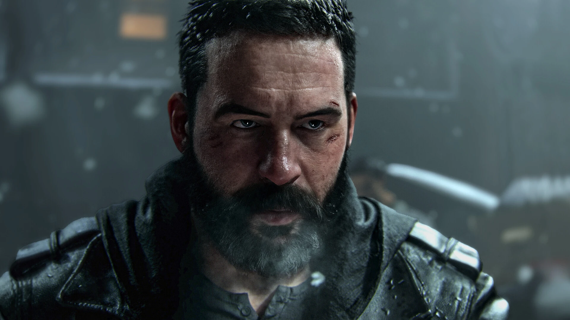 A close-up of a bearded, battle-worn soldier staring ahead in the rain