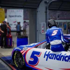 NASCAR 26 driver climbing into the No. 5 car