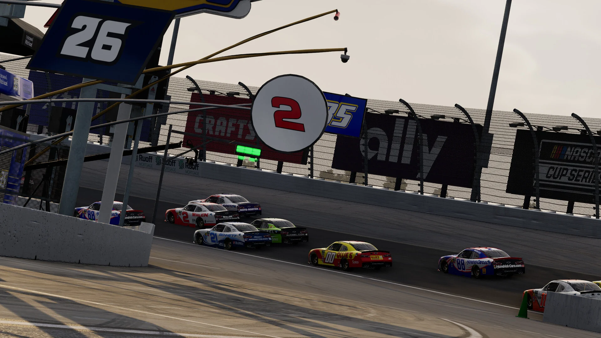 Cup cars run single file past the pit road position tower showing car numbers on a big oval