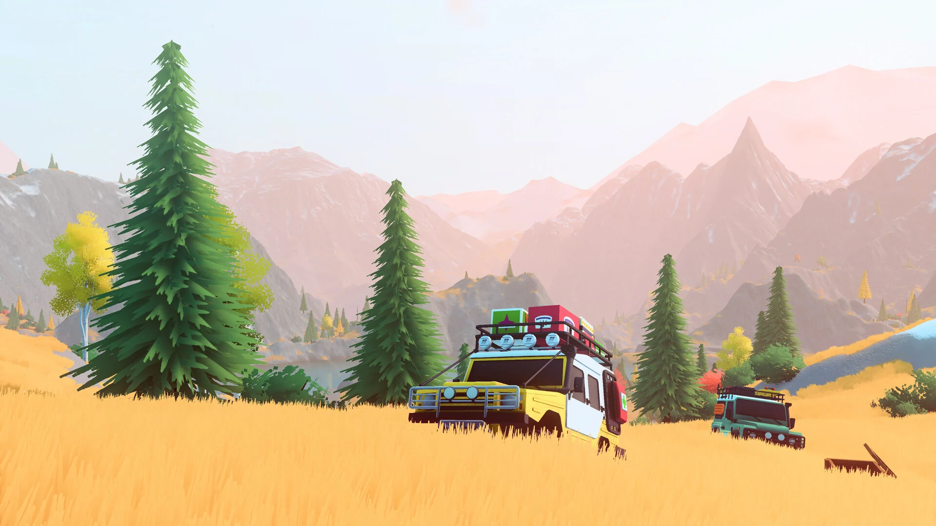 Two classic 4x4s loaded with roof gear drive through golden grass and pine trees below pink mountains