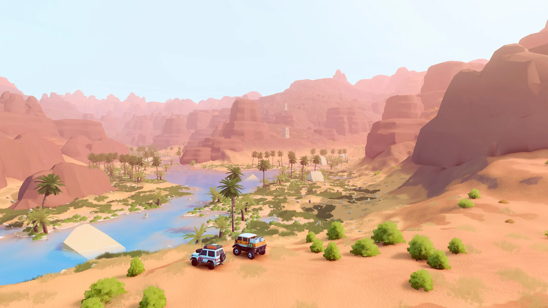 Two 4x4s drive past palm trees along a green river through red desert cliffs