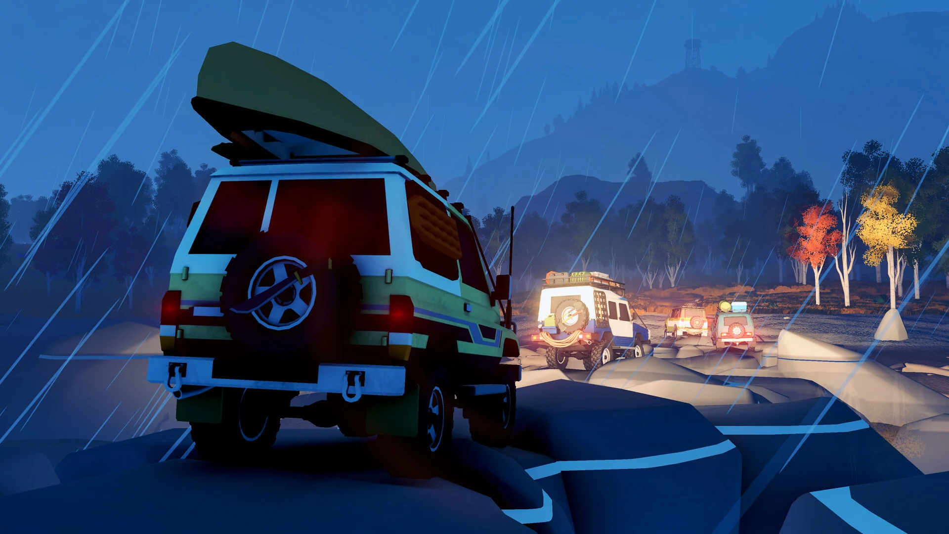 A green 4x4 with a canoe on the roof leads a convoy with headlights on along a rocky trail in the rain at night